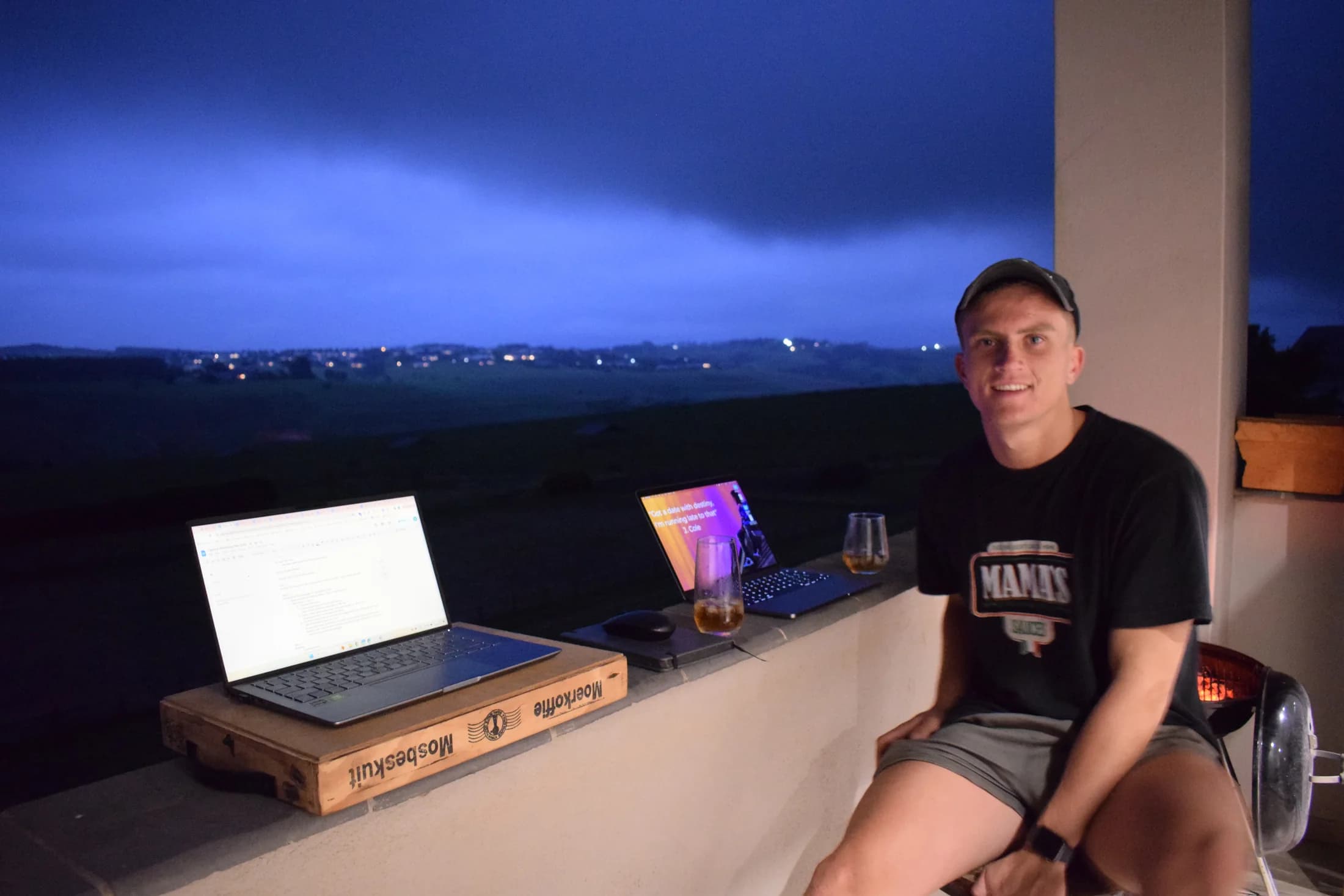 Cameron working beside two laptops at Mount Verde